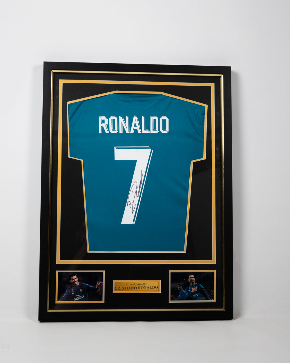 Framed signed Cristiano Ronaldo Real Madrid Champions League collector's replica jersey in a black and gold display frame