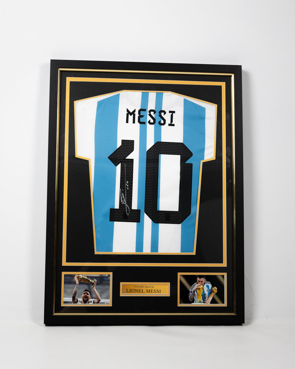 Framed signed Lionel Messi Argentina 2022 World Cup collector's replica jersey in a black and gold display frame